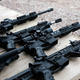 AR-15 rifles and other weapons are displayed on a table at a shooting range during the “Rod of Iron Freedom Festival” on October 12, 2019, in Greeley, Pennsylvania.